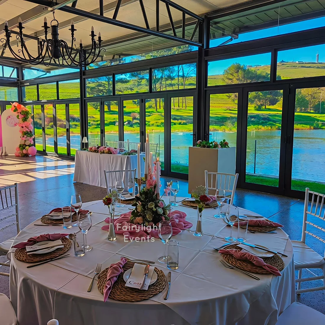 Elegant 60th birthday table setting overlooking the water, styled by Fairylight Events