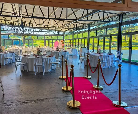 Red carpet wedding venue styling with round tables